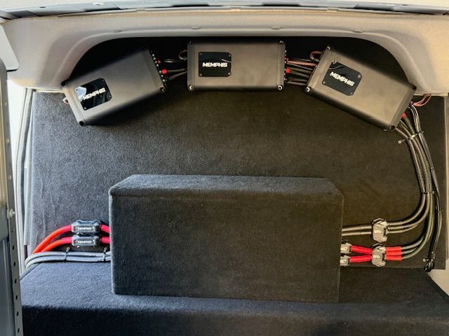 Car audio system with three amplifiers and a subwoofer installed in a vehicle. Car audio system with three amplifiers and a subwoofer installed in a vehicle.