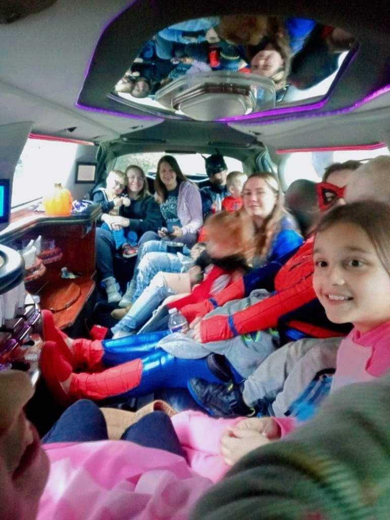 Children and adults seated inside the party bus