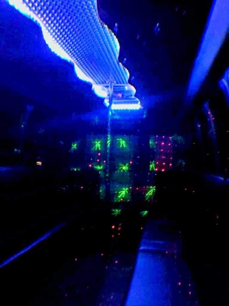Blue-lit interior with a glowing ceiling and colorful control-panel lights in a dark space.