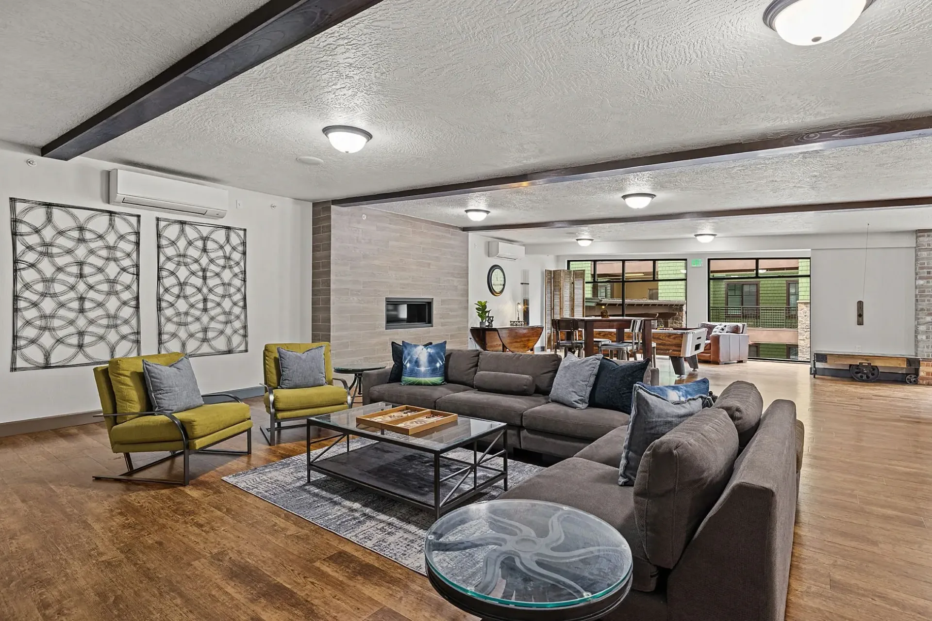 Spacious living area with a large sectional sofa, accent chairs, and a fireplace.