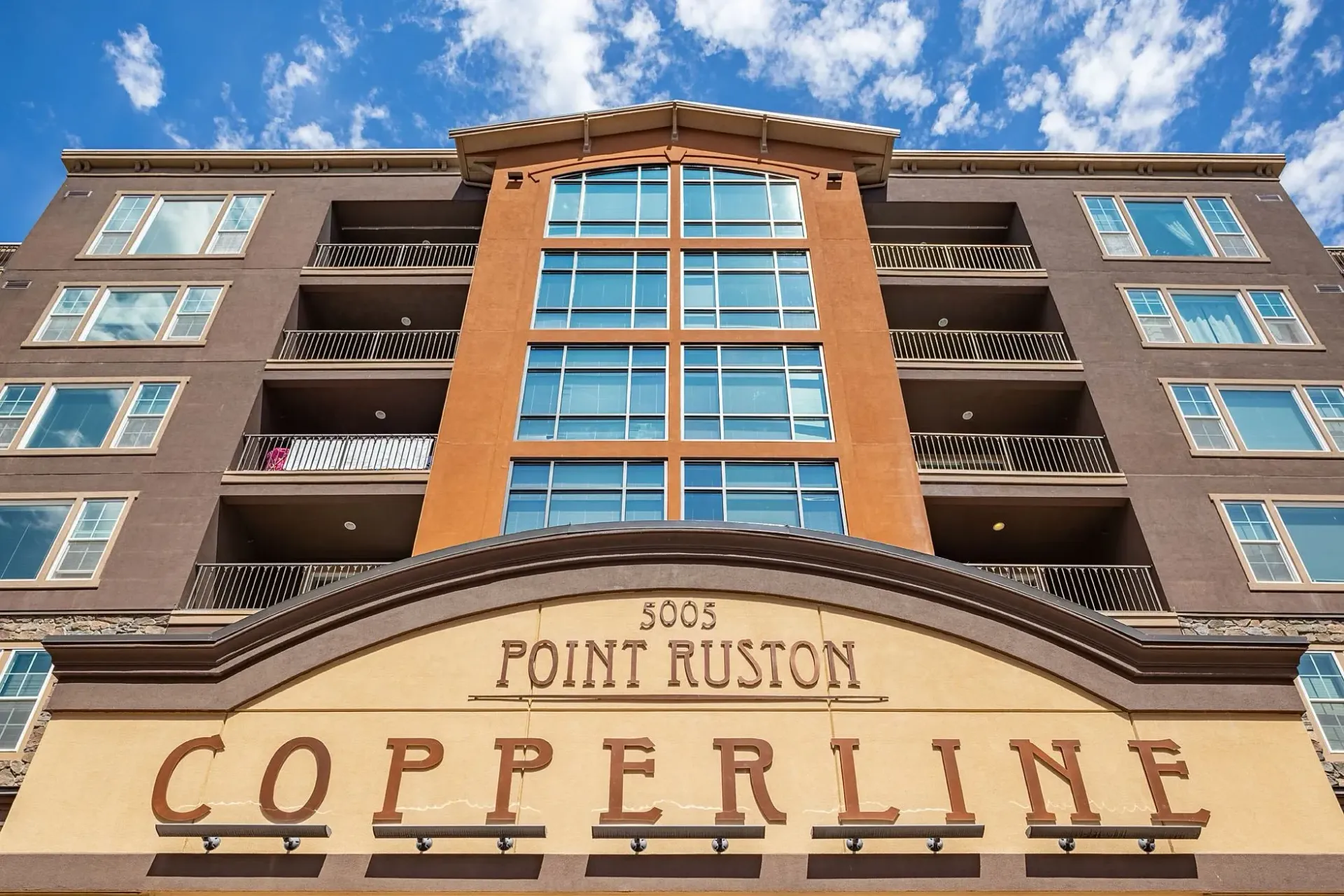 The Copperline apartment building exterior with 'POINT RUSTON' signage above the entrance.