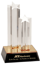 An ACE Hardware trophy honoring Elra Sillas for 15 years of service, featuring two clear star-topped pillars on a base.