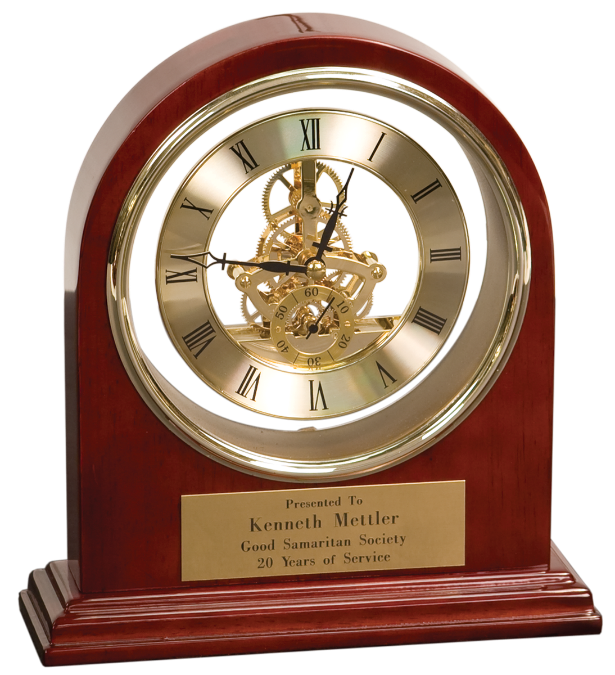 A wooden mantel clock with a skeleton dial and a gold plaque honoring Kenneth Mettler for 20 years of service.