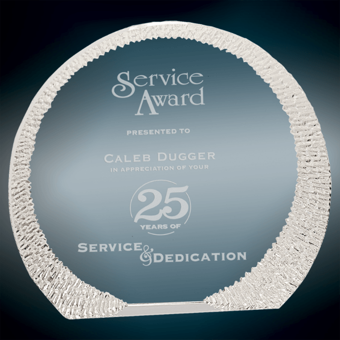 A round, glass service award inscribed to Caleb Dugger for 25 years of service and dedication.