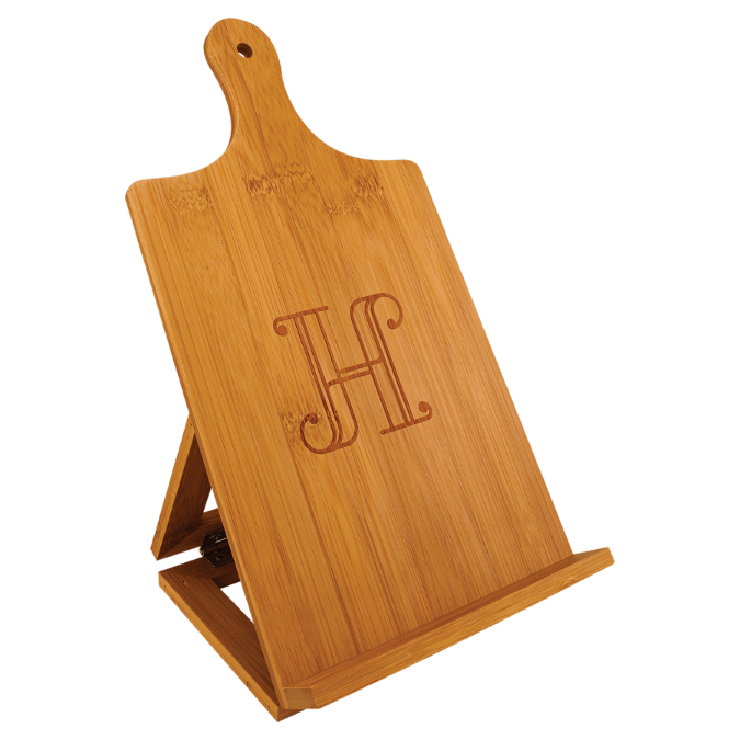 A bamboo cookbook stand shaped like a cutting board with a decorative 