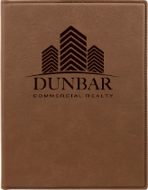 Brown leather notebook cover featuring the Dunbar Commercial Realty logo with three stylized building silhouettes.