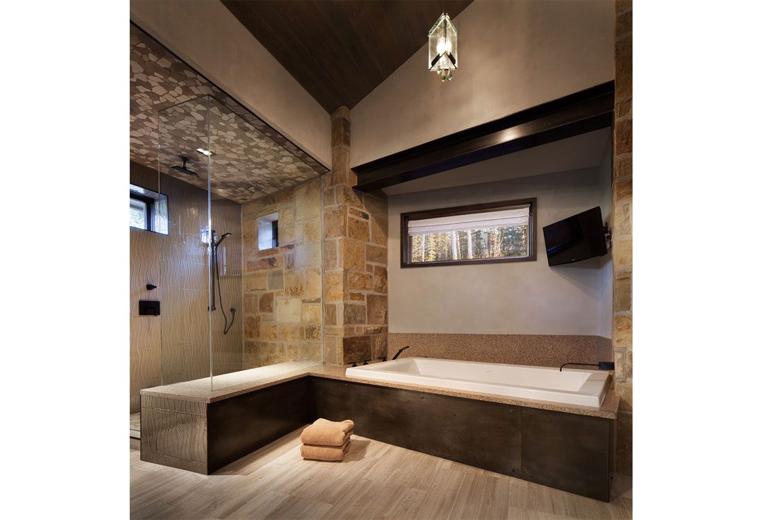 A bathroom with a large tub and a walk in shower.