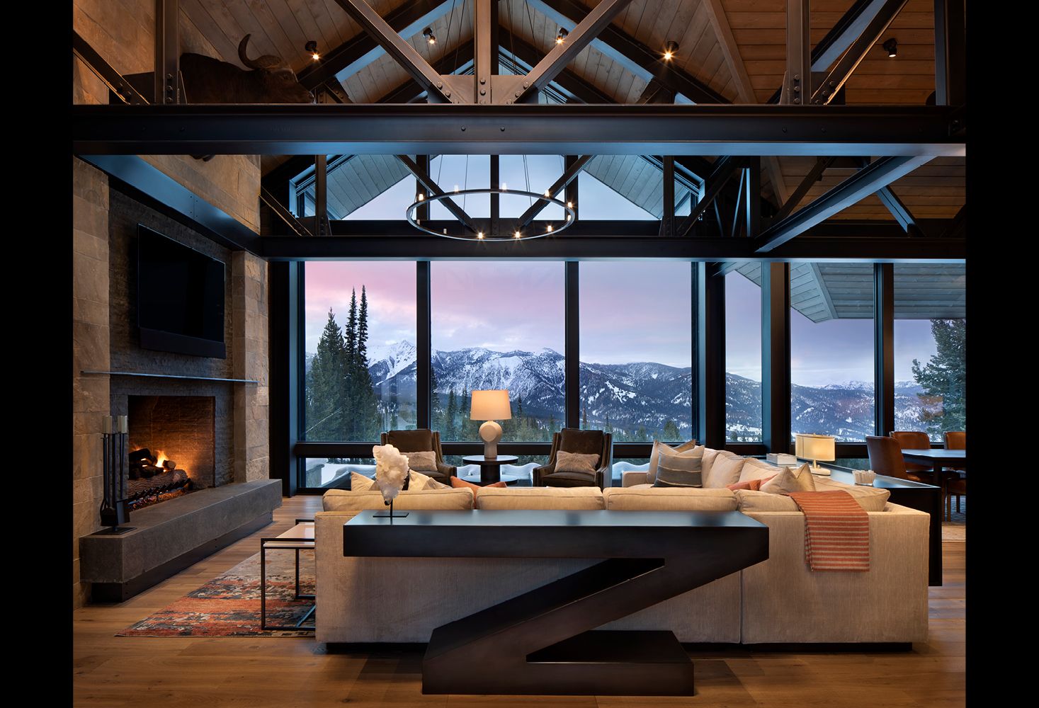 A living room with a couch a fireplace and a table