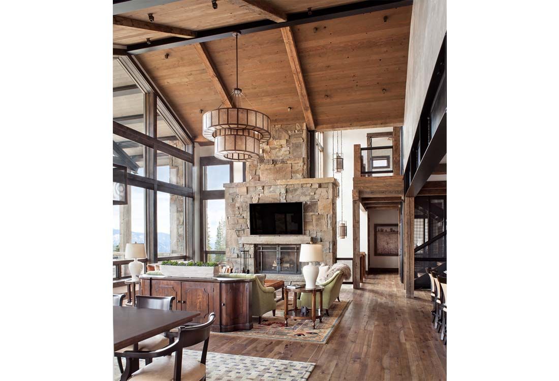 A living room with a fireplace and a television on the wall.