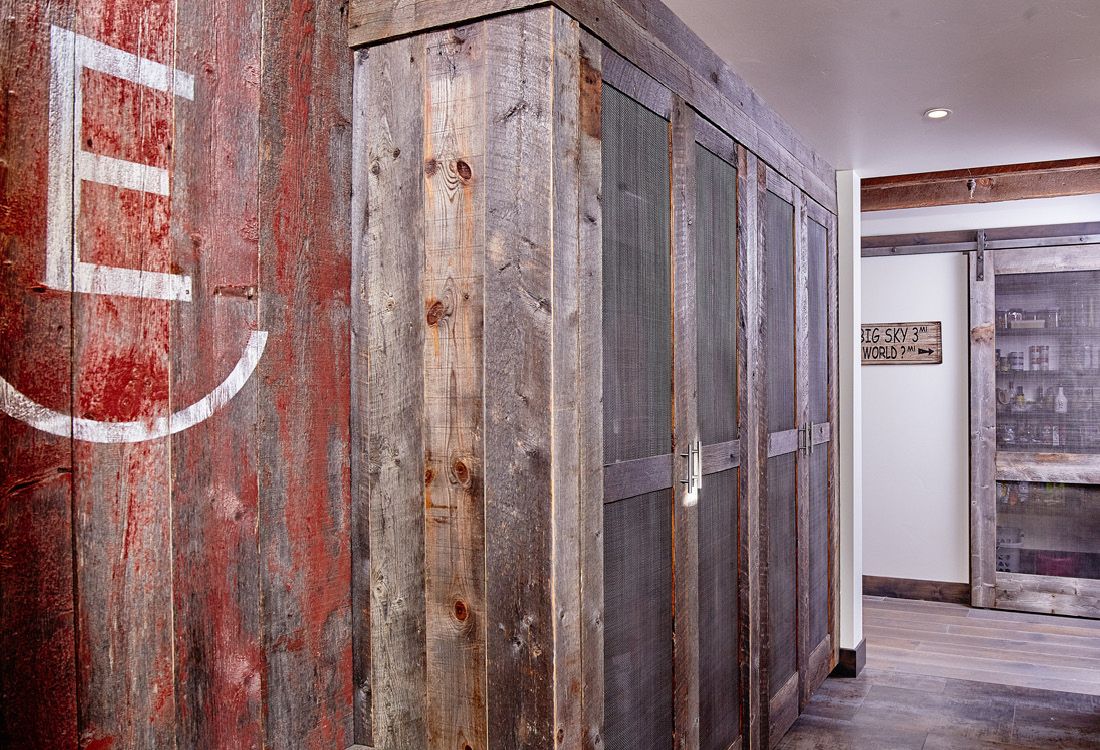 A hallway with wooden cabinets and a red wall with the letter e painted on it.