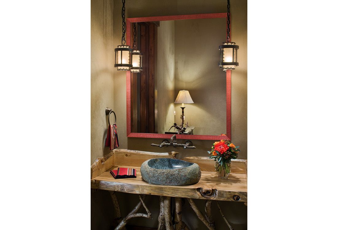 A bathroom with a sink and a large mirror.