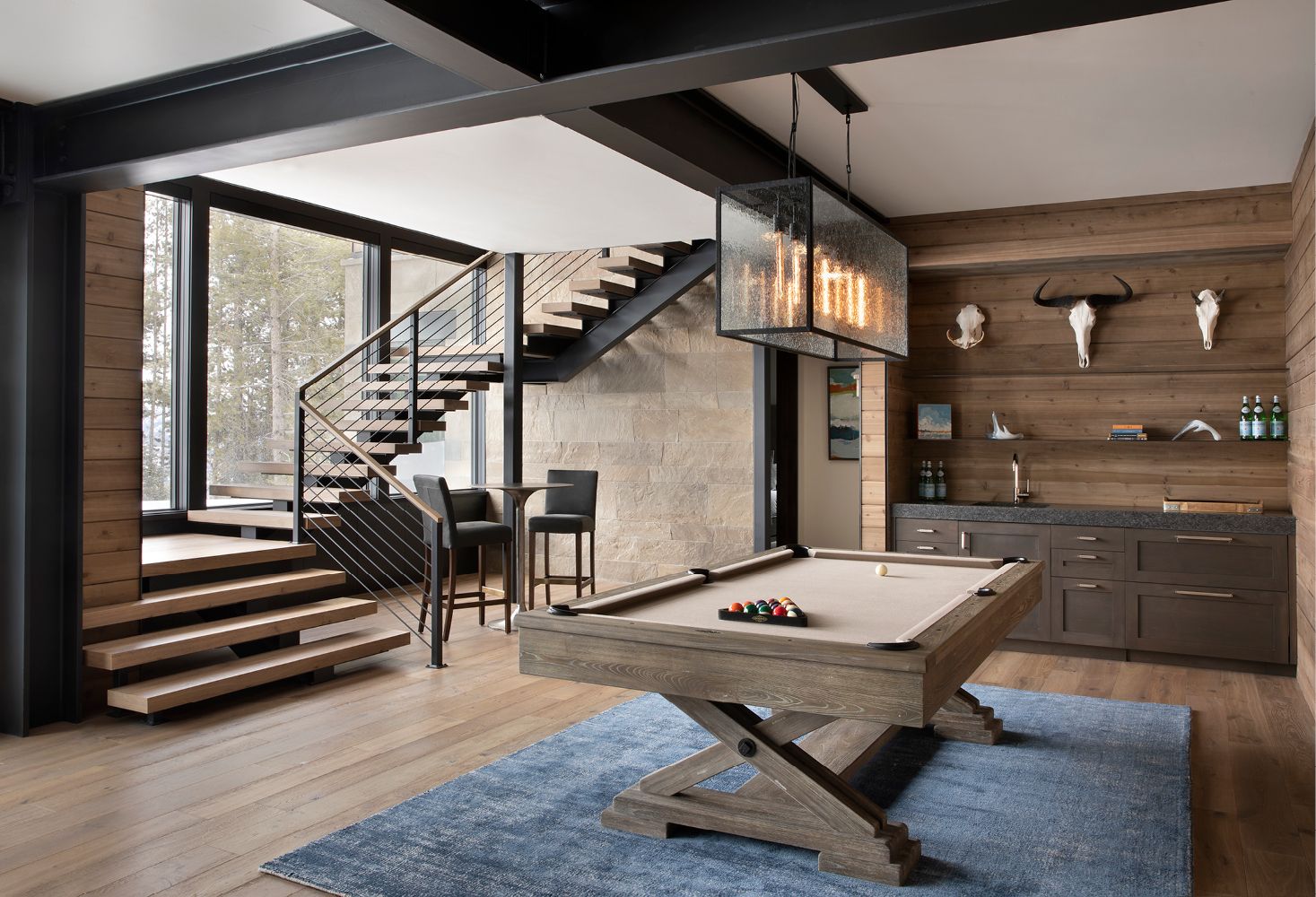 There is a pool table in the middle of the room.