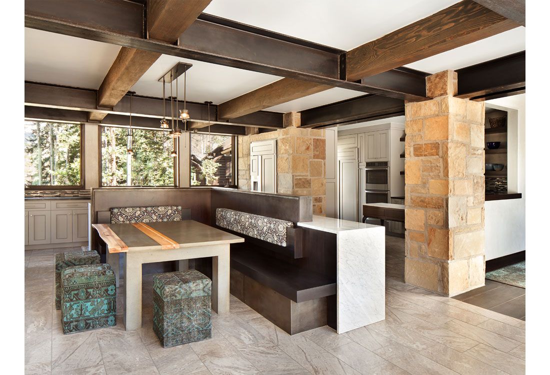 A dining room with a table and benches in it