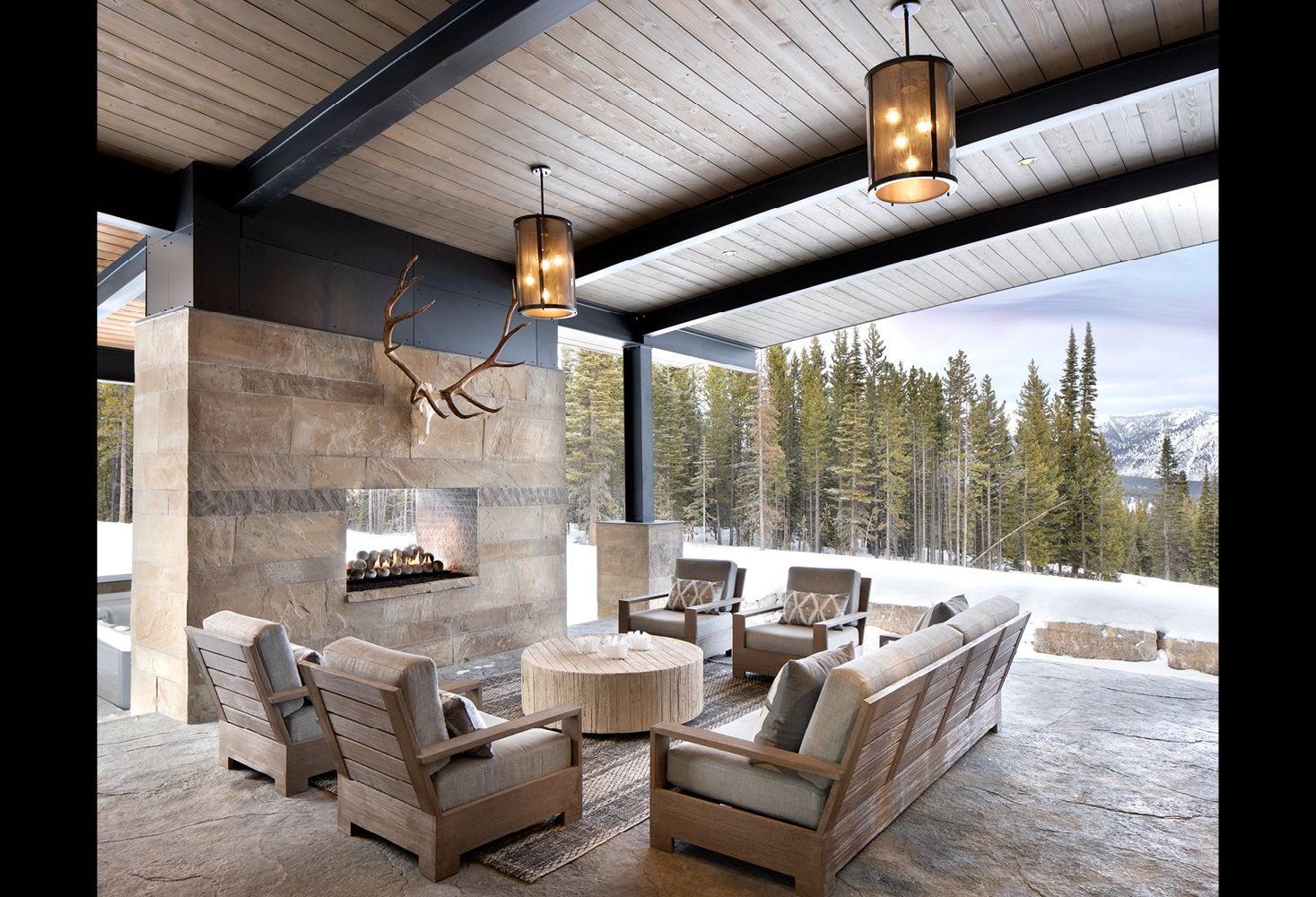 A living room with a fireplace and a deer head on the wall
