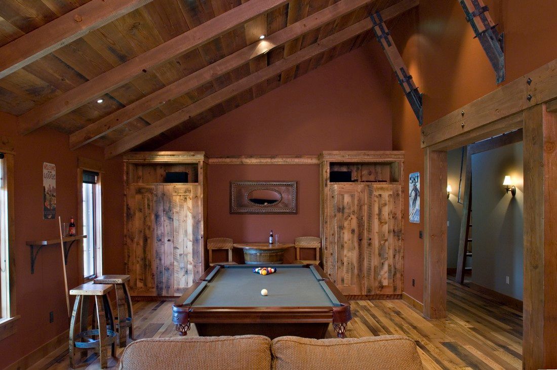 There is a pool table in the middle of the room.