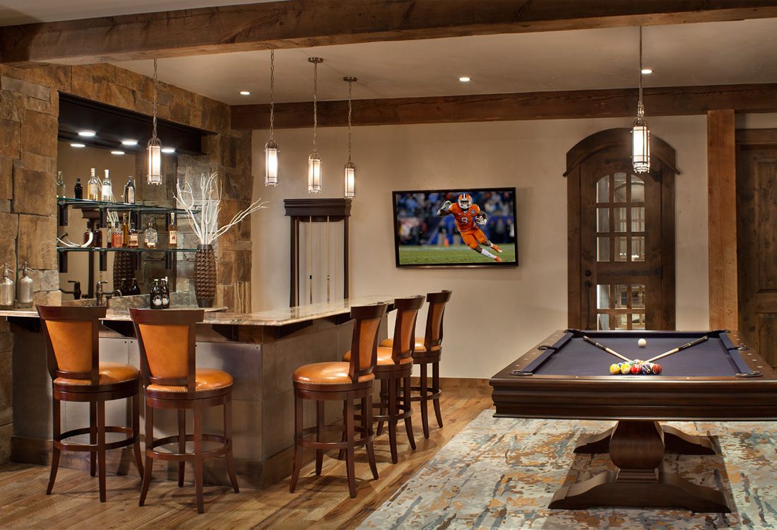 There is a pool table in the middle of the room.