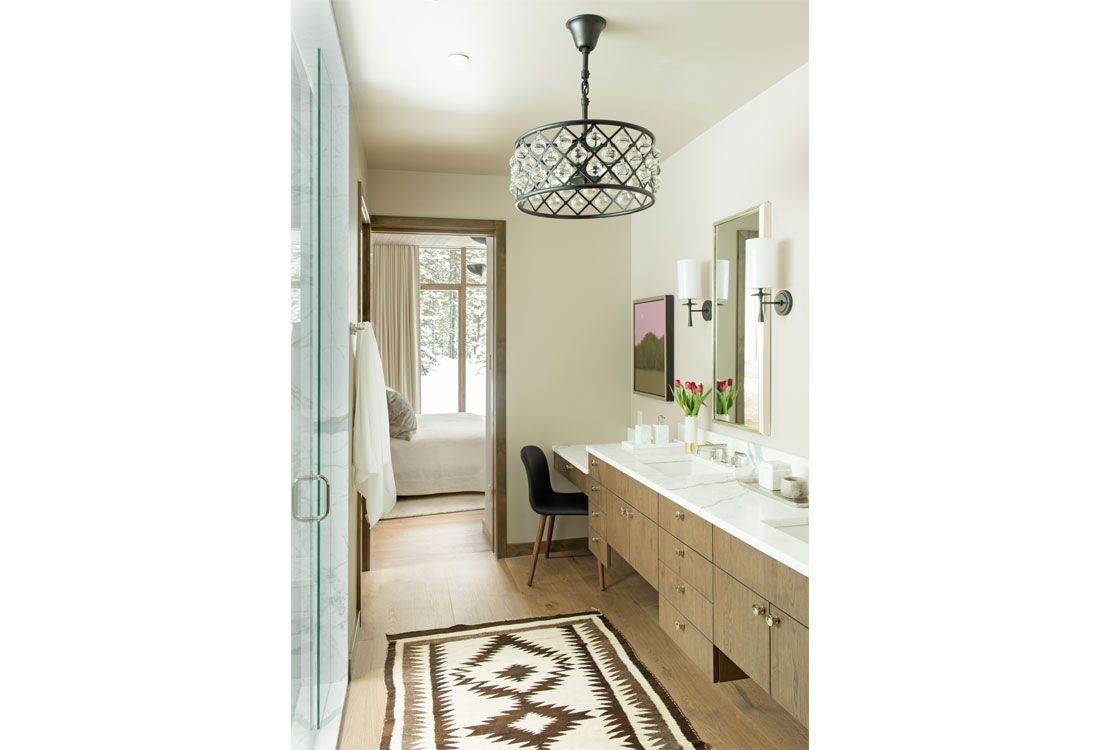 A bathroom with two sinks and a rug on the floor.