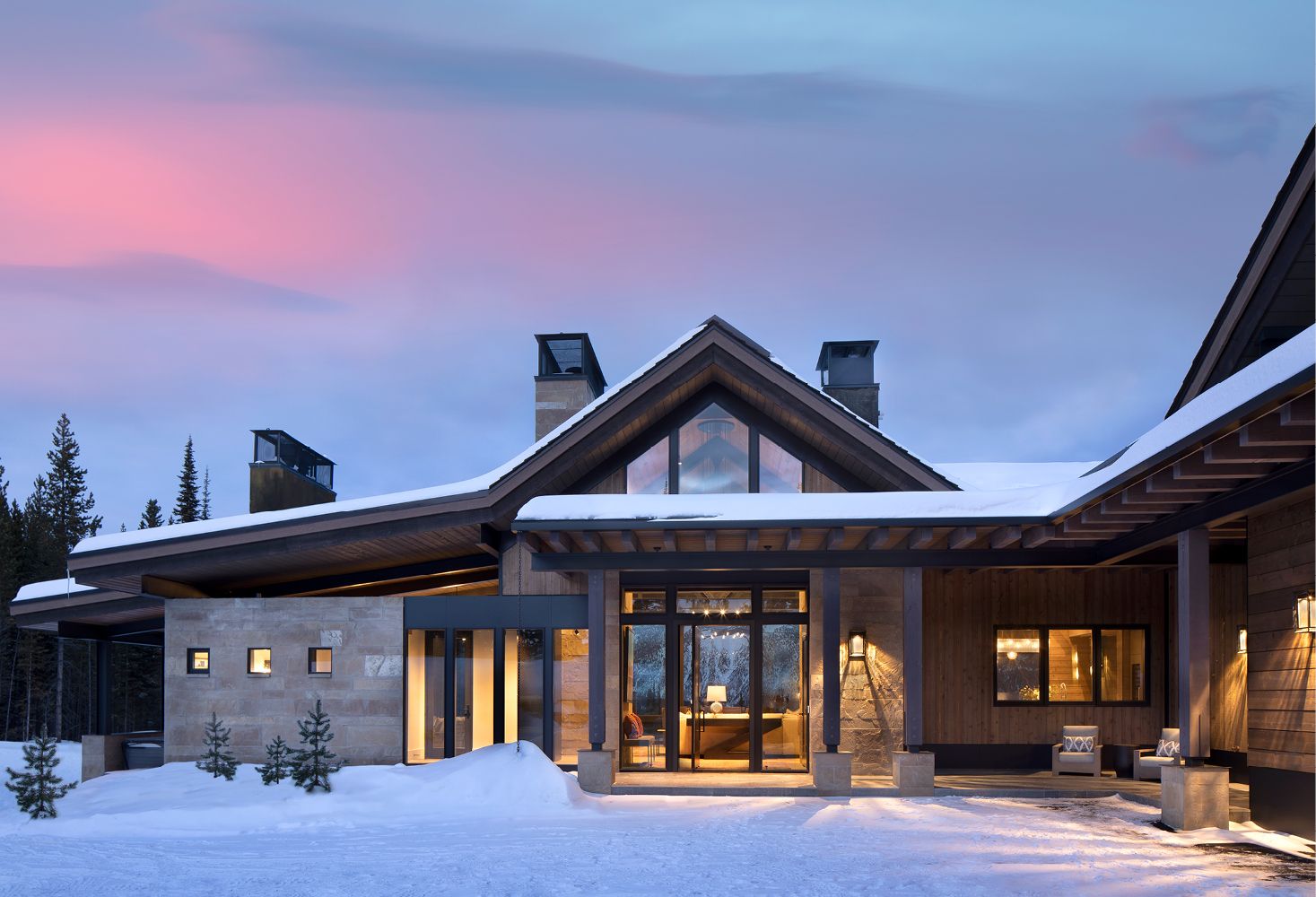 A large house with snow on the ground in front of it