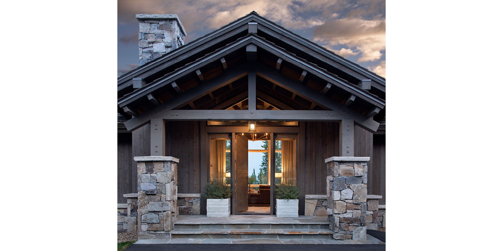 A large house with a stone porch and stairs