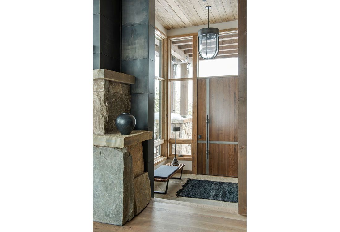 A living room with a fireplace and a wooden door.