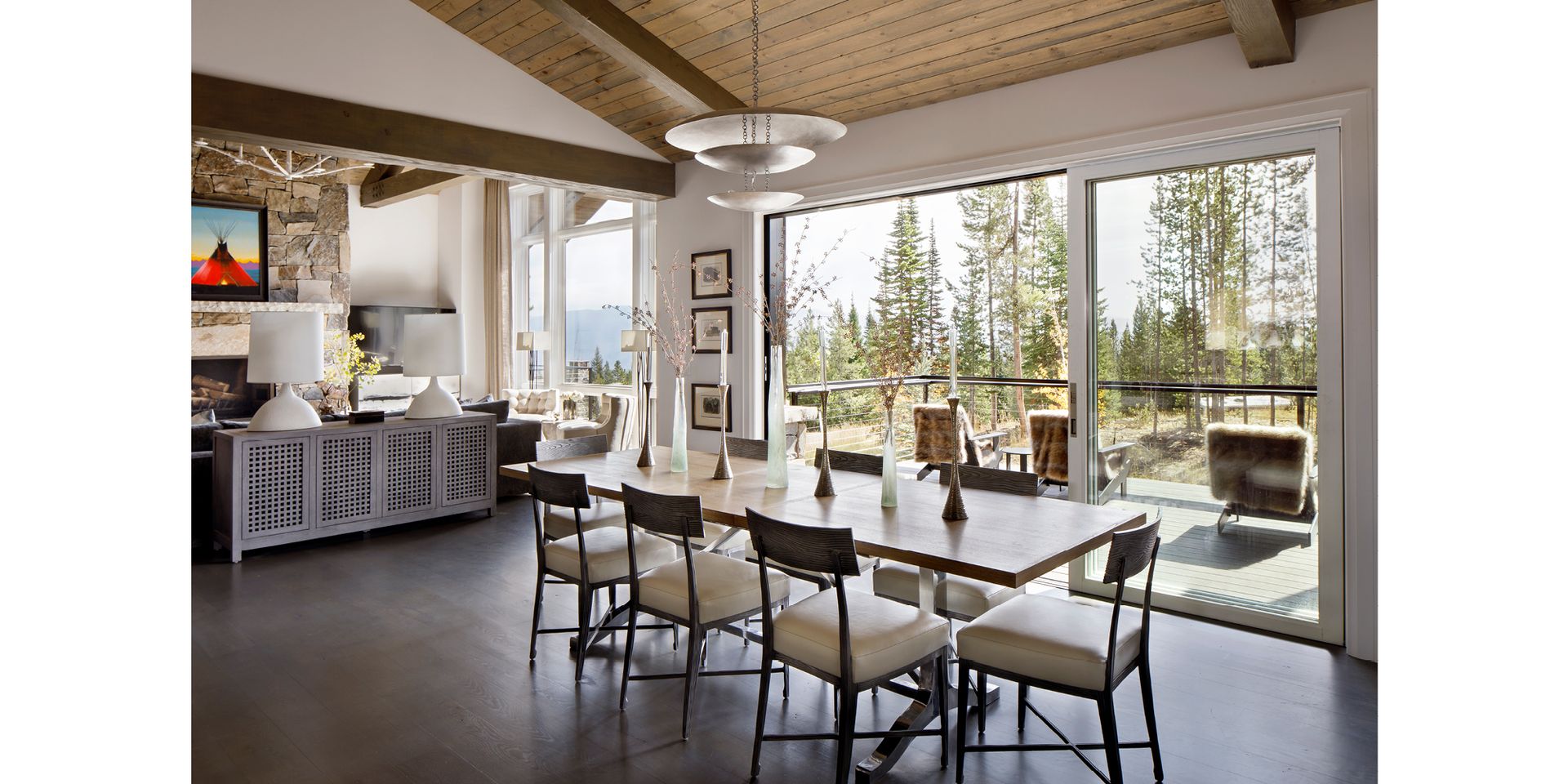 A dining room with a large table and chairs