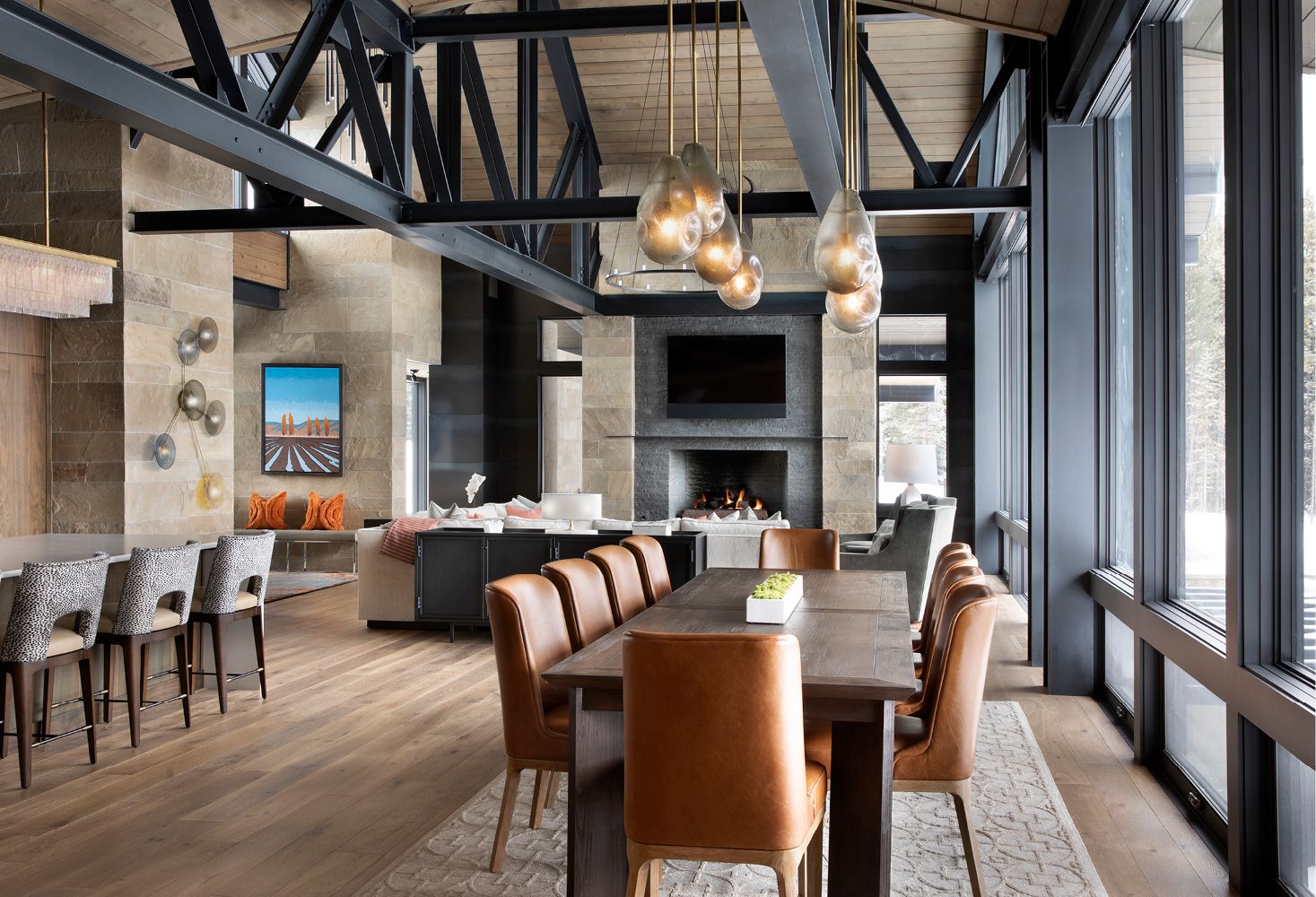 A large dining room with a long table and chairs and a fireplace.