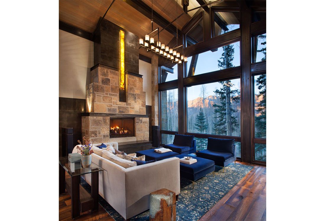 A living room with a fireplace and a lot of windows