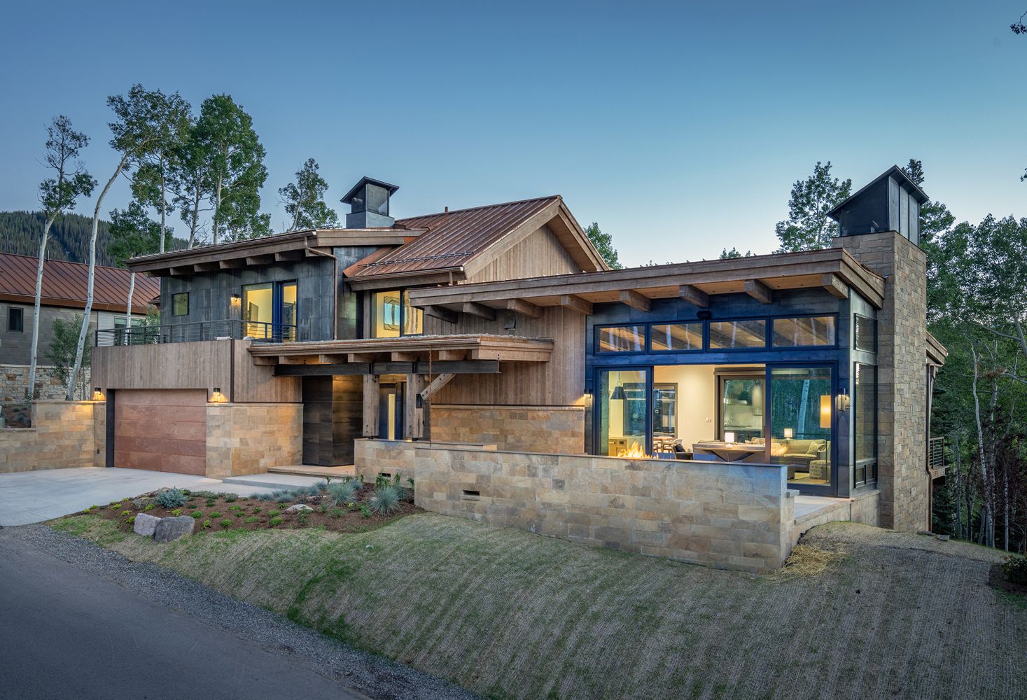 A large house with a lot of windows is sitting on top of a hill.