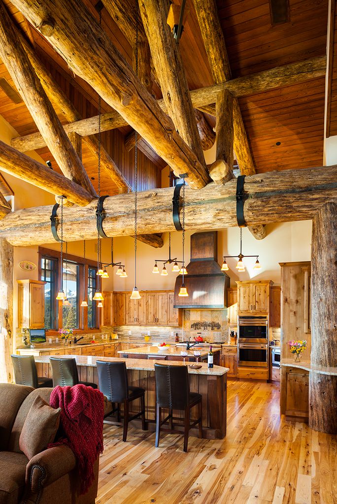 A kitchen with wooden beams hanging from the ceiling