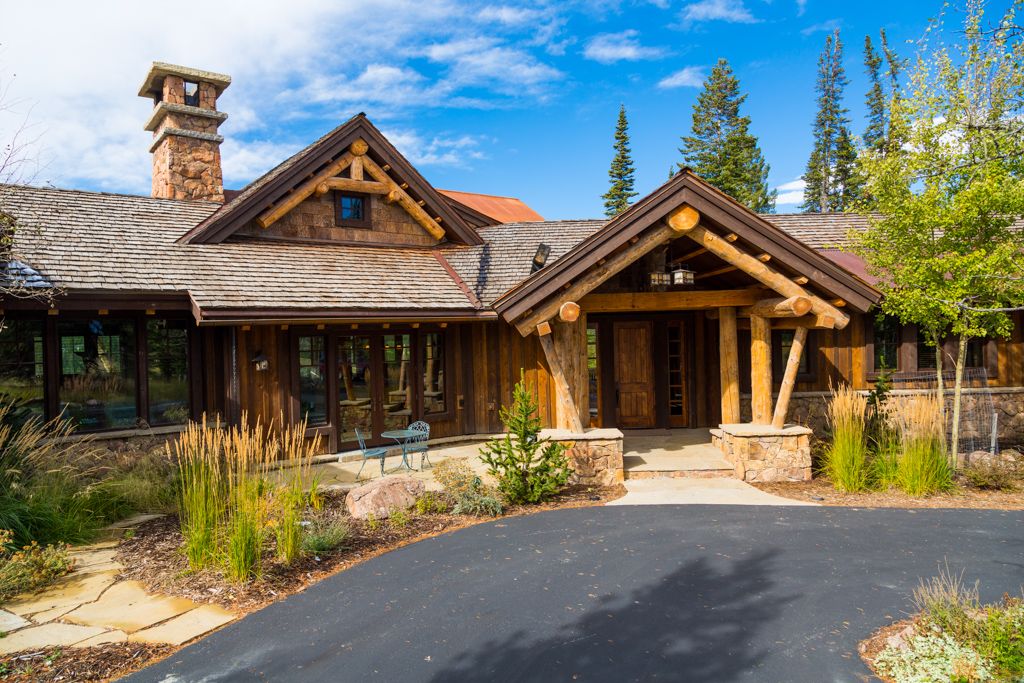A large wooden house with a chimney on the roof