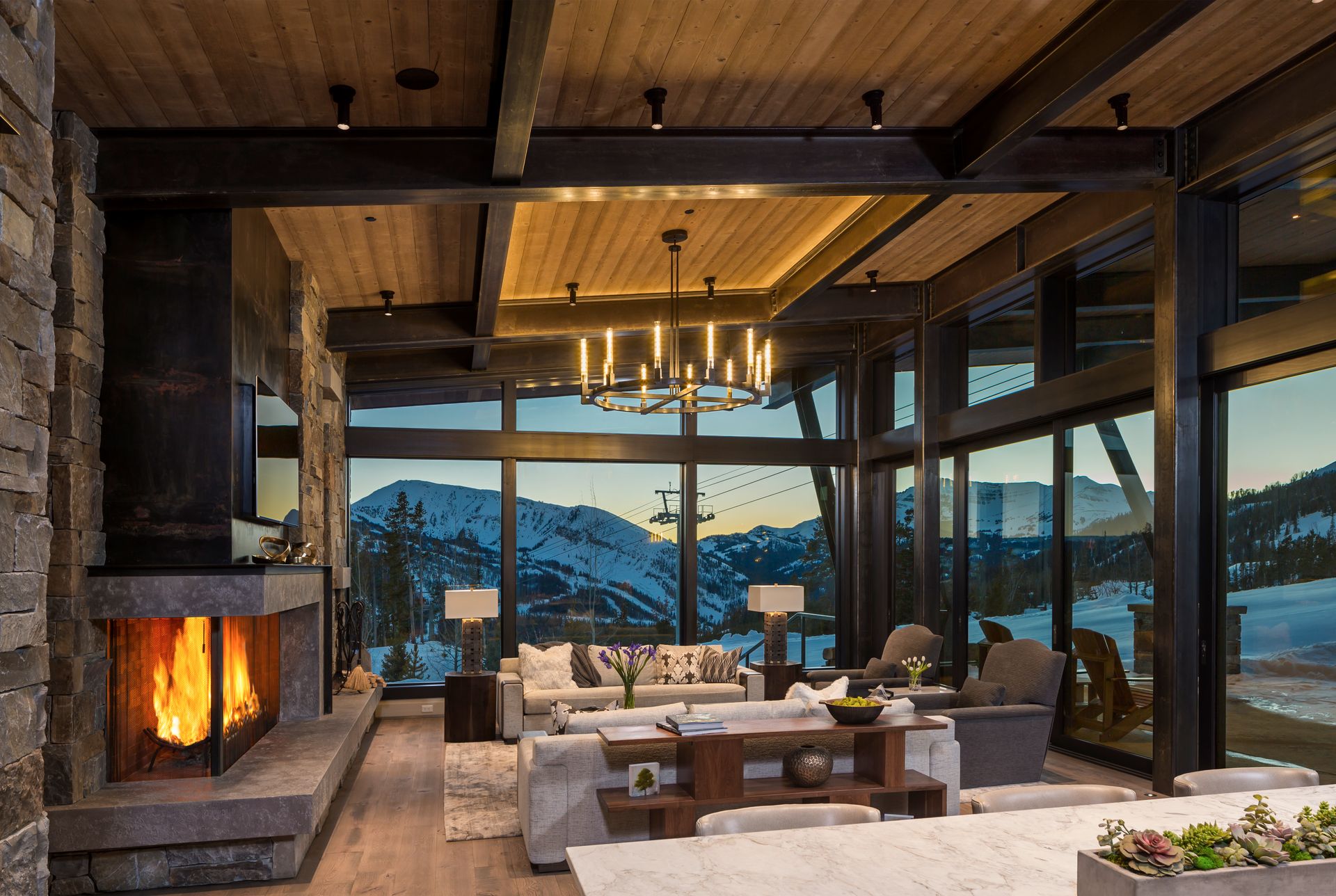 A living room with a fireplace and a lot of windows