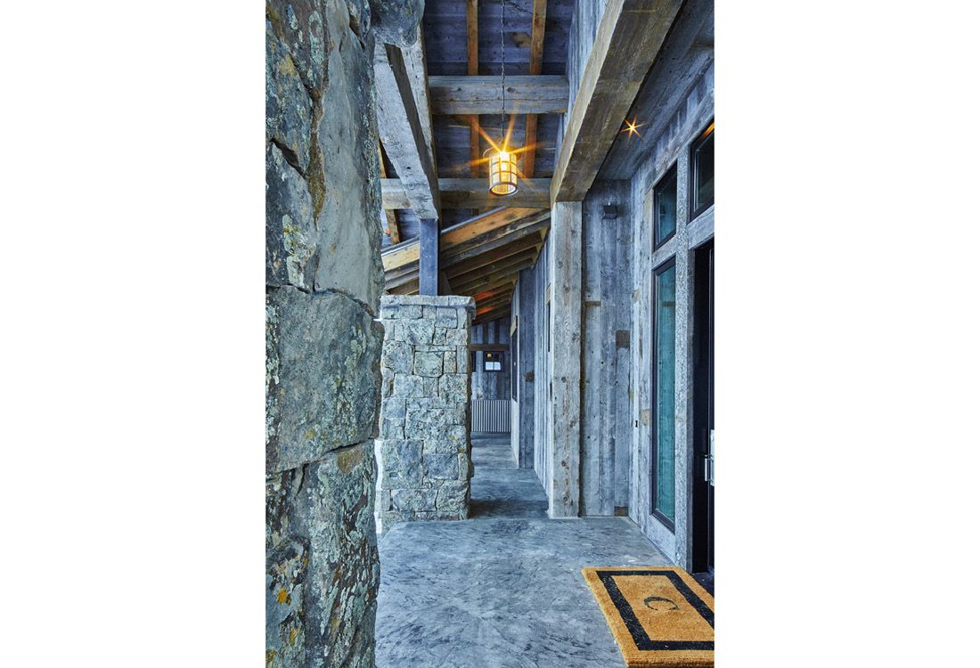 A hallway in a house with a lantern hanging from the ceiling.