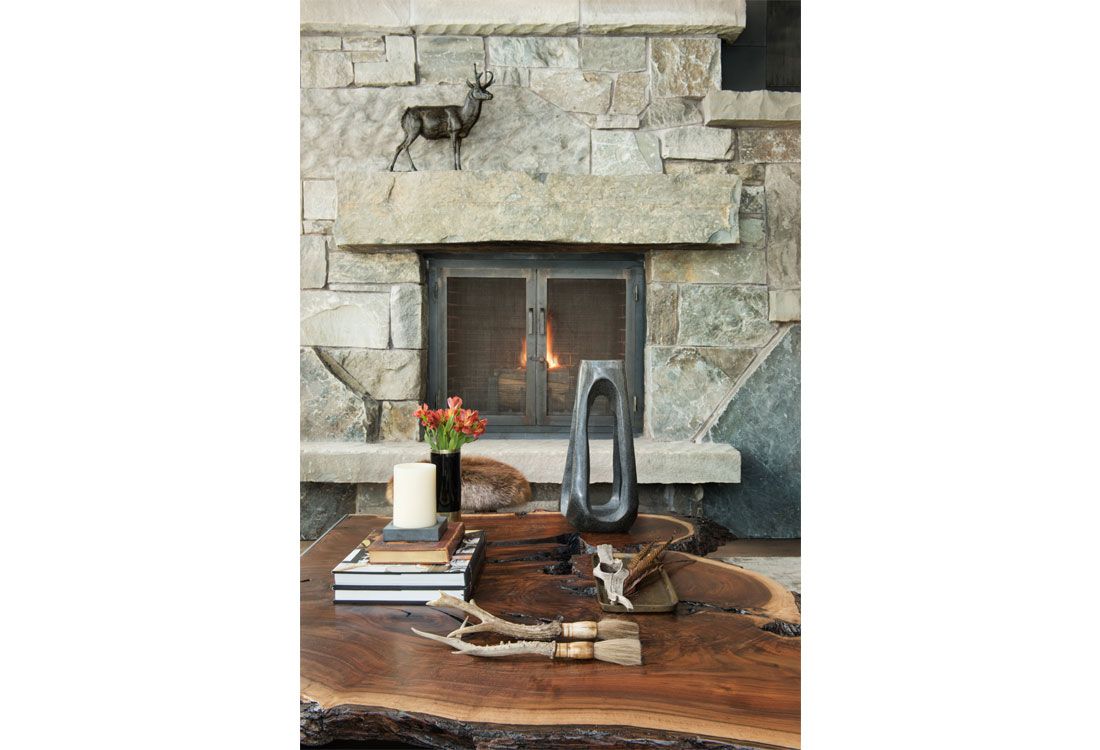 A living room with a fireplace and a wooden table.