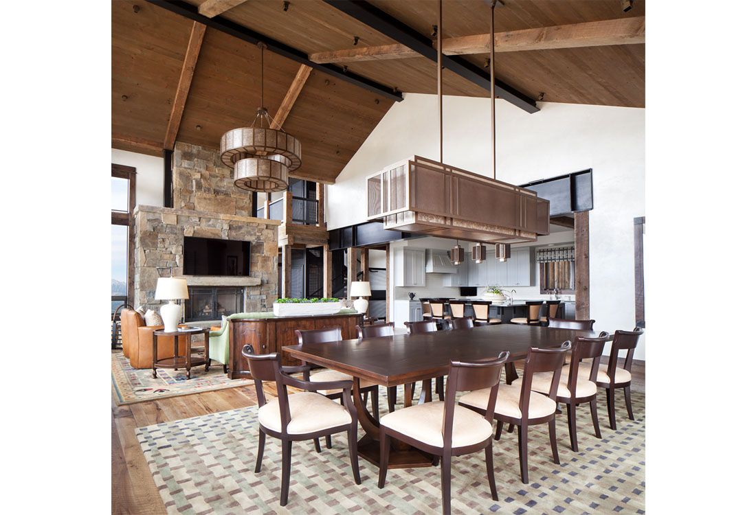 A large dining room with a wooden table and chairs.