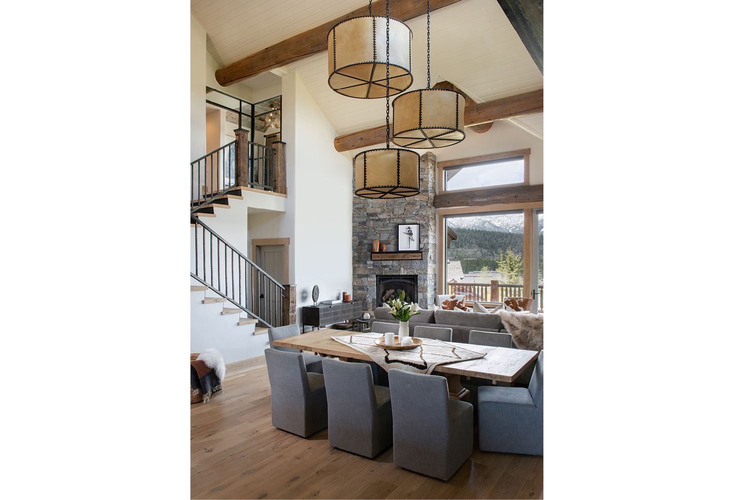 A dining room with a table and chairs and a fireplace.