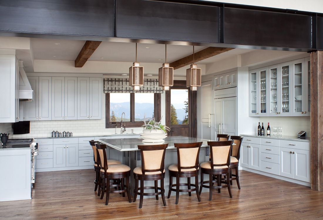 A kitchen with a table and chairs in it