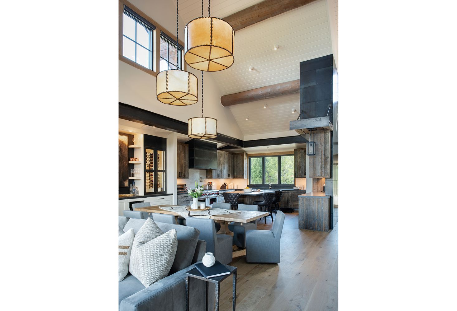 A living room with a couch , table , chairs and a fireplace.