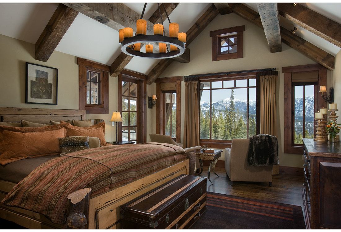 A bedroom with a large bed and lots of windows