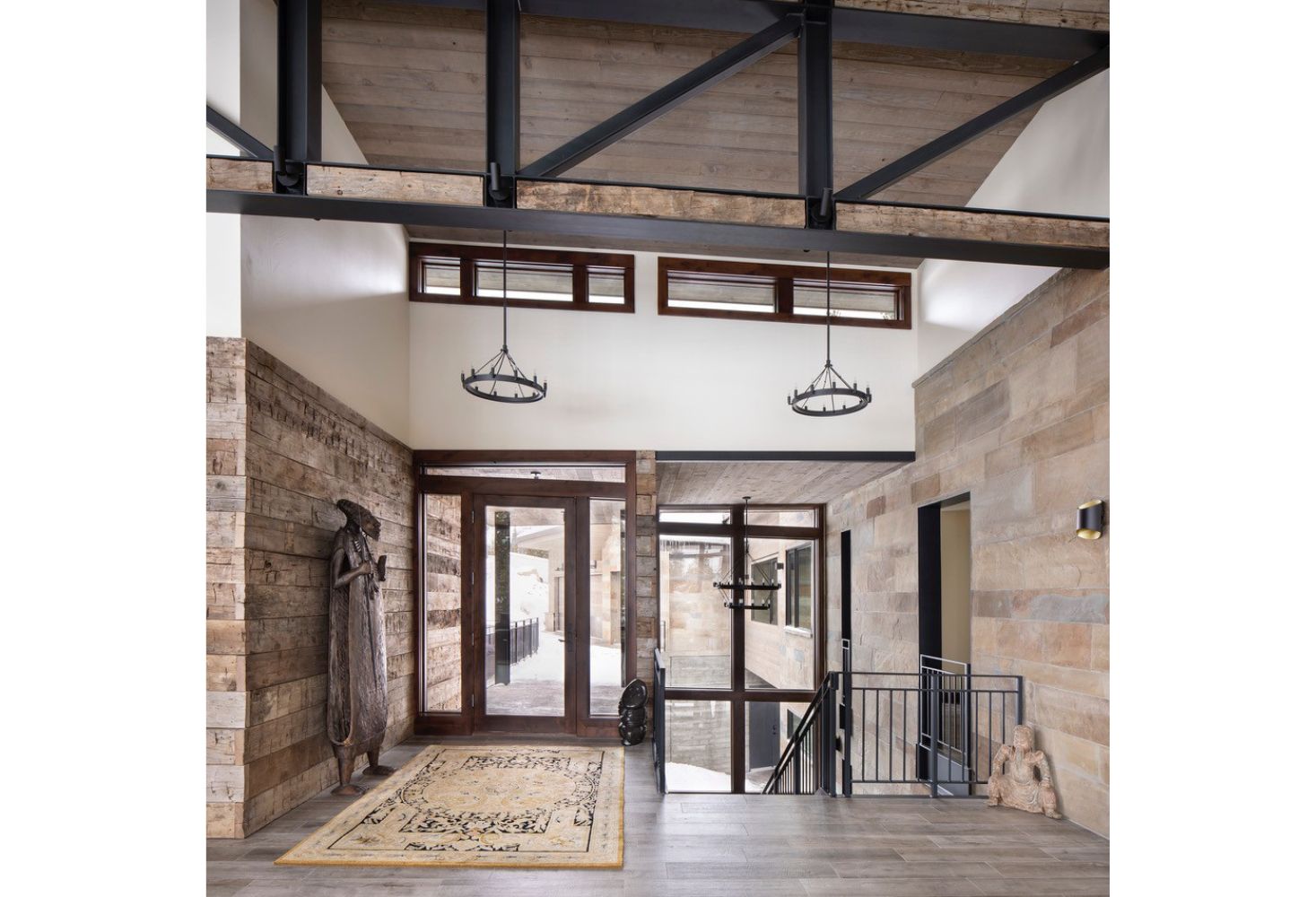 A large hallway with a staircase leading up to the second floor of a house.