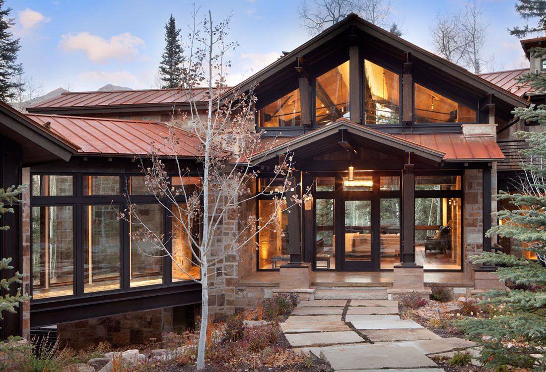 A large house with a copper roof and lots of windows