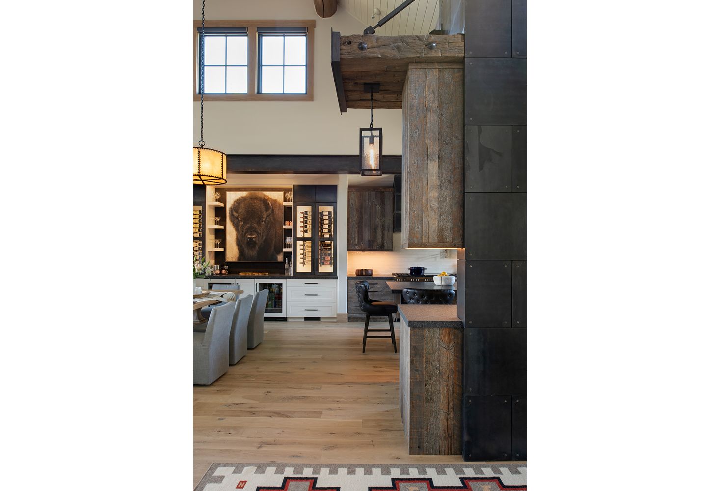 A kitchen and dining room in a house with wooden floors.