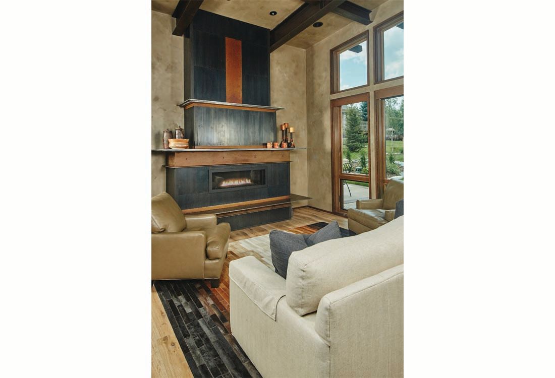 There is a fireplace in the middle of the living room.