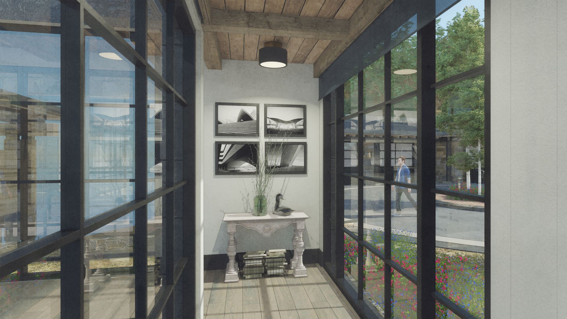 A hallway with lots of windows and a table in the middle.