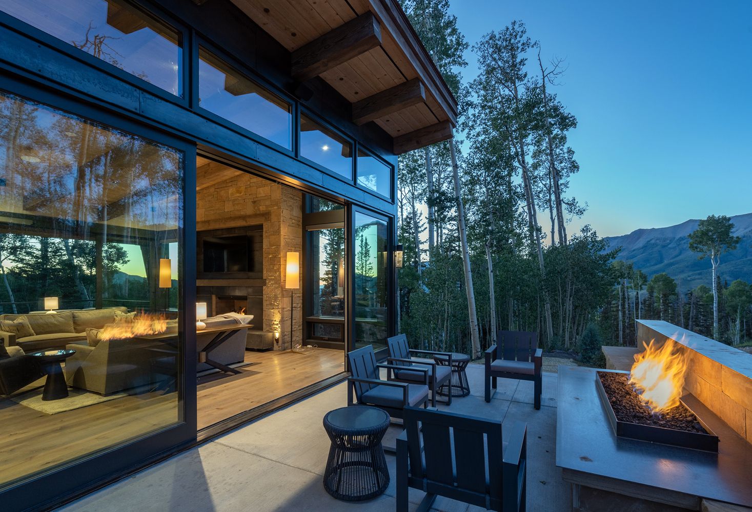 There is a fire pit in the backyard of a house.