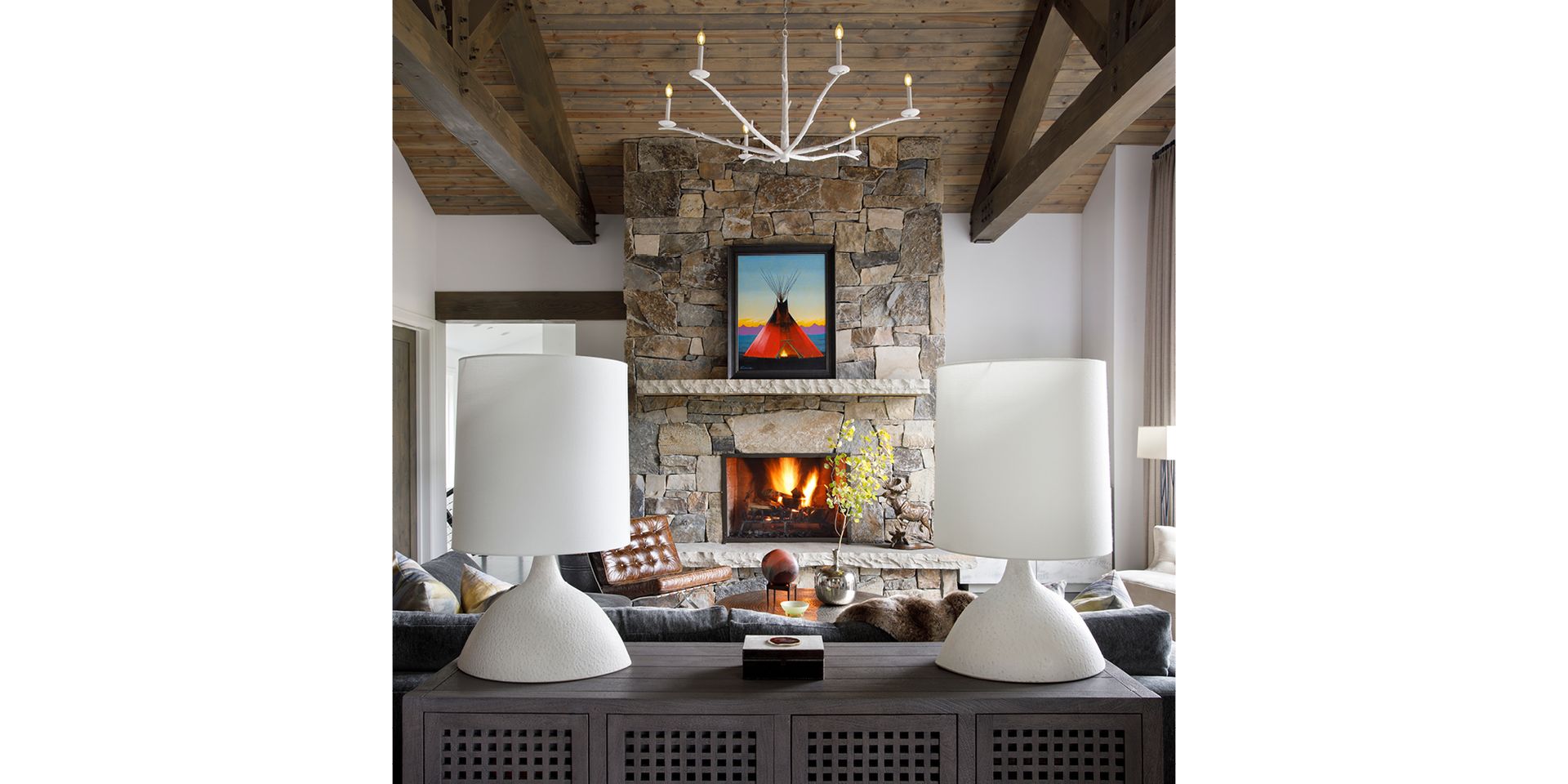A living room with a fireplace and a picture on the wall.