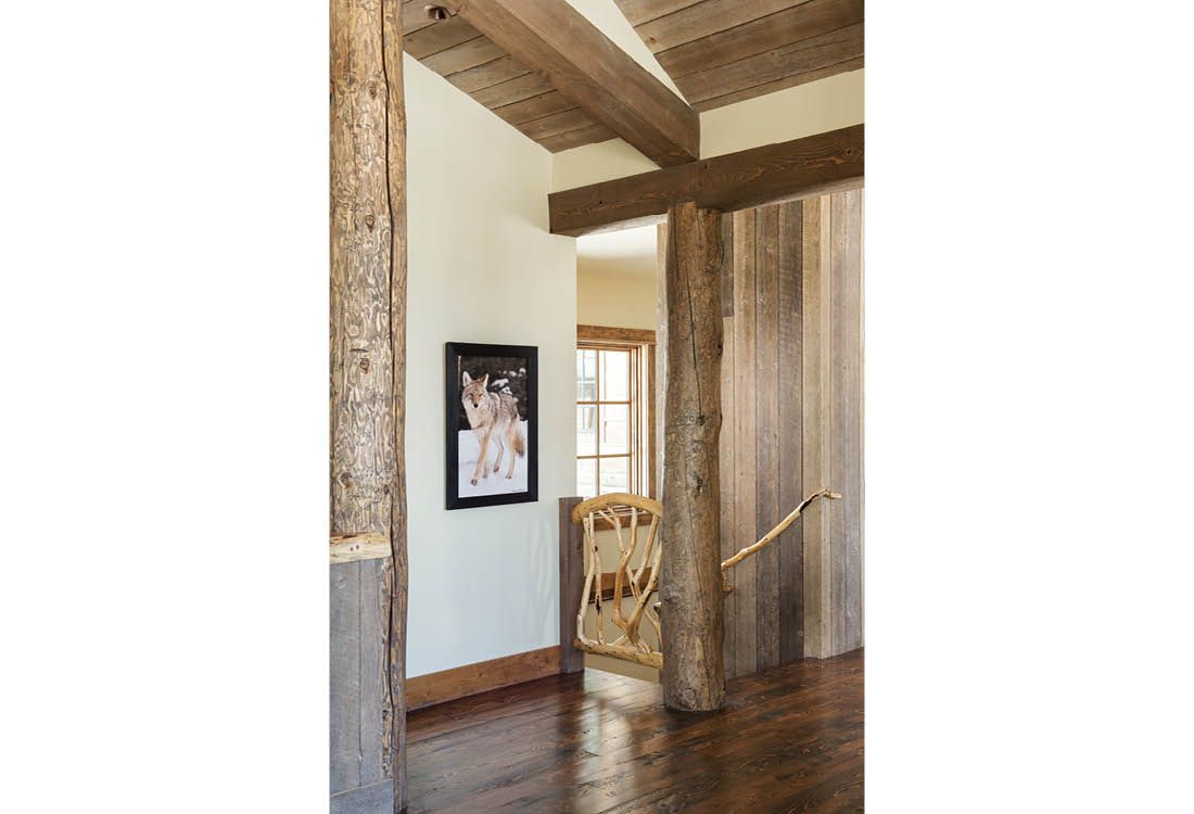 A hallway with wooden beams and a picture on the wall.