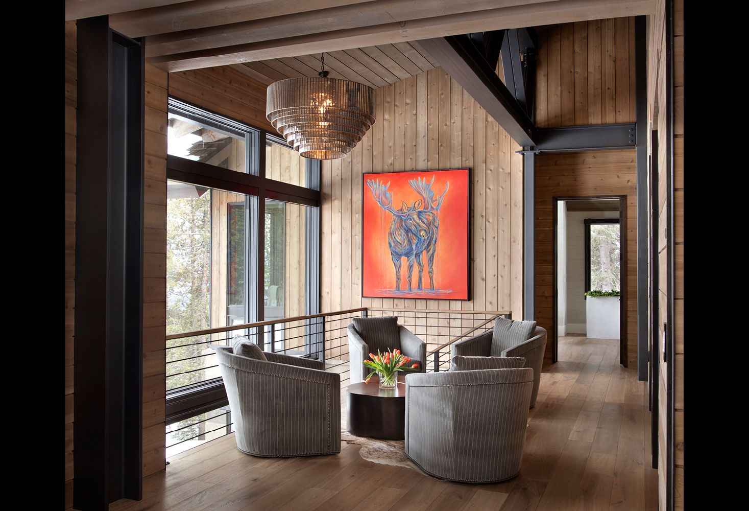A living room with a painting of a moose on the wall