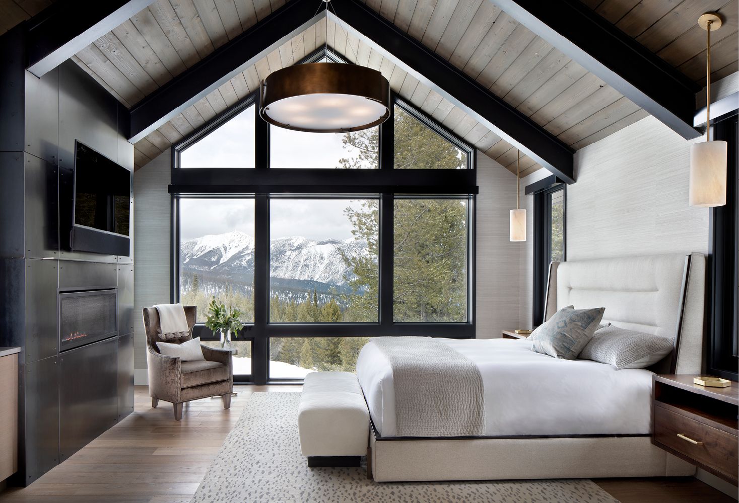 A bedroom with a vaulted ceiling and a large bed