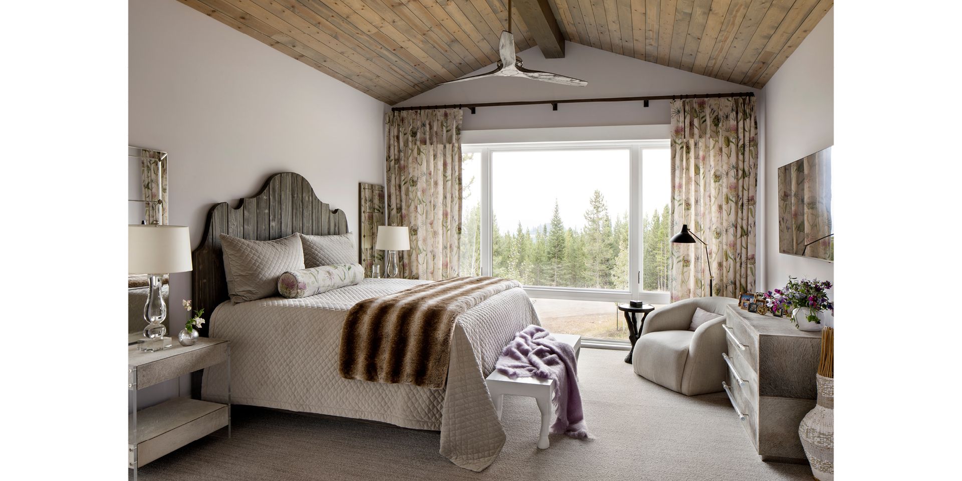 A bedroom with a large bed and a large window.