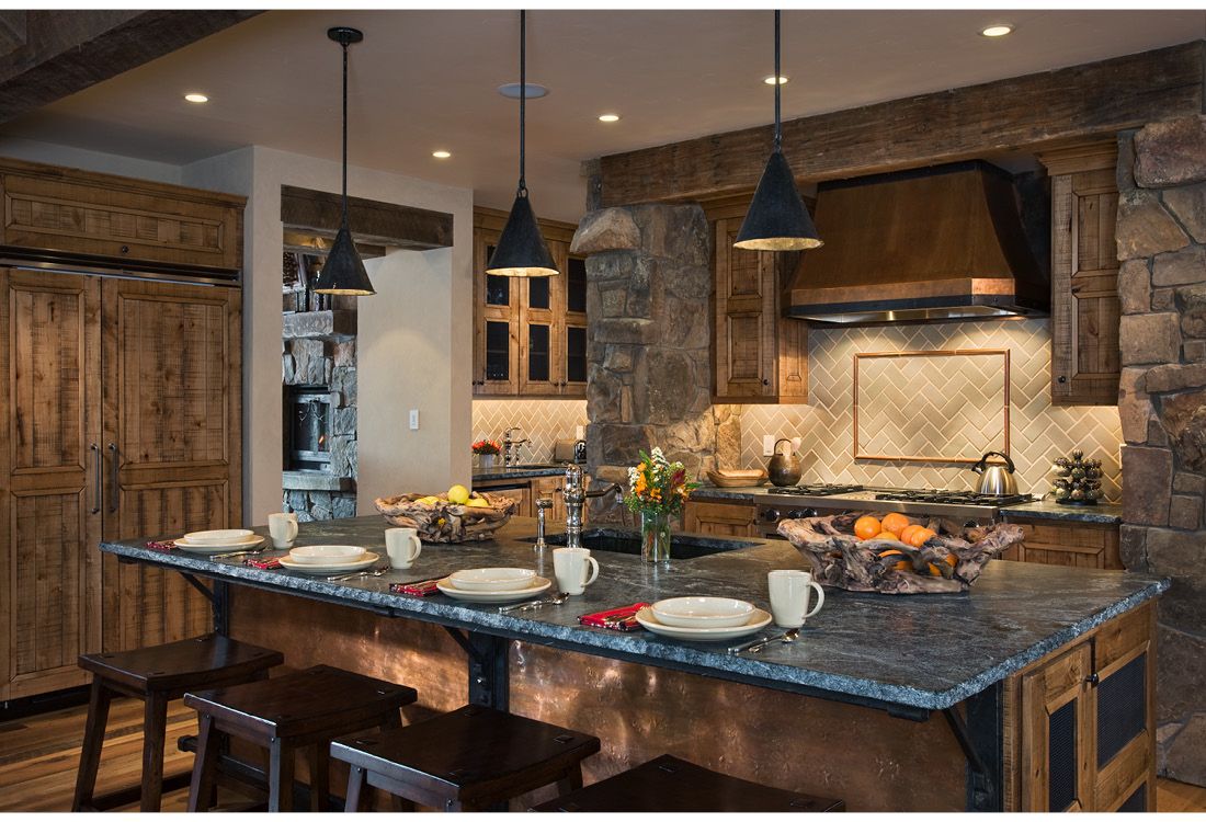 A kitchen with a large island and stools